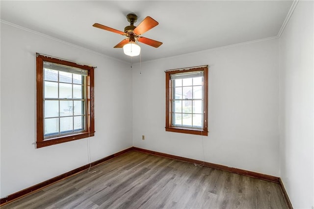 15 Tulip Dr, Gretna, LA 70053 - empty room with healthy amount of natural light, wood finished floors, ornamental molding, and ceiling fan