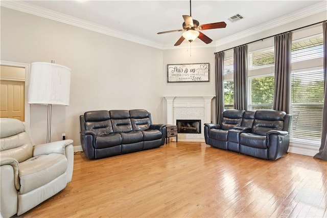 24 Minter Dr, Mandeville, LA 70471 - living room featuring ceiling fan, light wood-type flooring, a fireplace, and crown molding