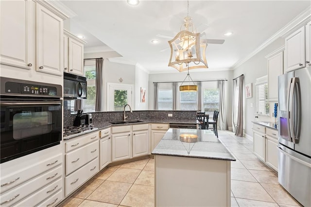 24 Minter Dr, Mandeville, LA 70471 - kitchen with black appliances, light tile patterned floors, a peninsula, ornamental molding, and a kitchen island