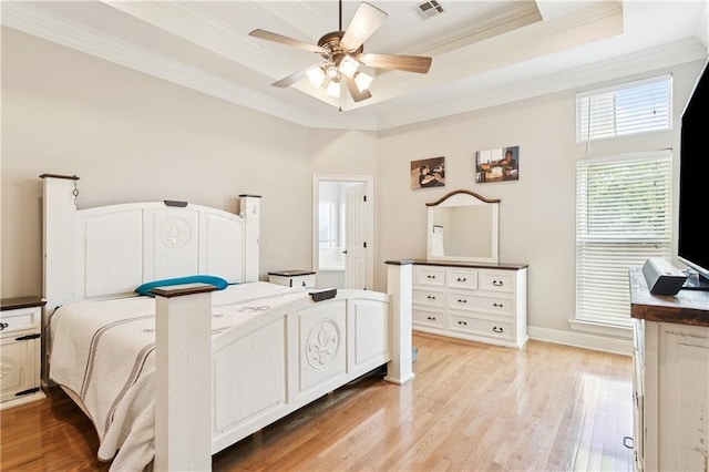24 Minter Dr, Mandeville, LA 70471 - bedroom with ornamental molding, a tray ceiling, light wood-style floors, and a ceiling fan
