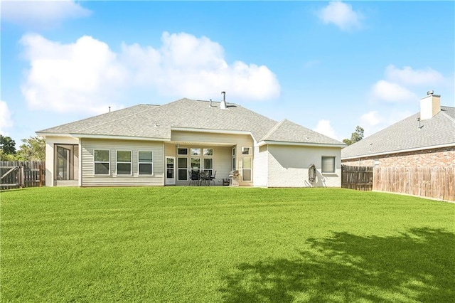 24 Minter Dr, Mandeville, LA 70471 - rear view of house with a fenced backyard, roof with shingles, and a sunroom