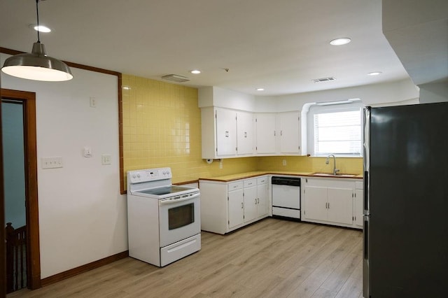 6 Gelbke Dr, Gretna, LA 70053 - kitchen featuring white appliances, white cabinetry, light wood-type flooring, decorative backsplash, and recessed lighting