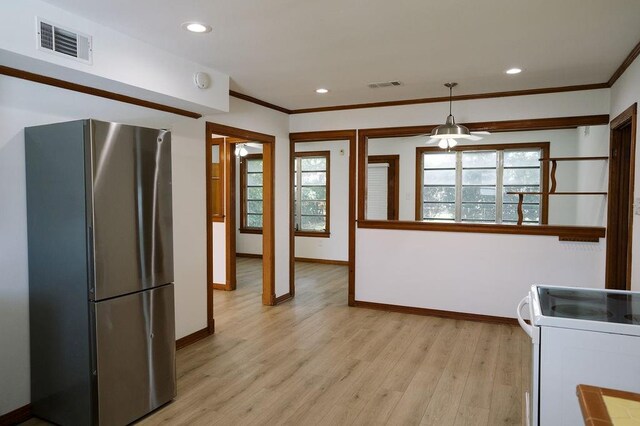 6 Gelbke Dr, Gretna, LA 70053 - kitchen with freestanding refrigerator, white range with electric cooktop, light wood-style flooring, crown molding, and recessed lighting