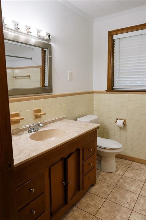 6 Gelbke Dr, Gretna, LA 70053 - bathroom featuring tile walls, vanity, crown molding, tile patterned flooring, and wainscoting