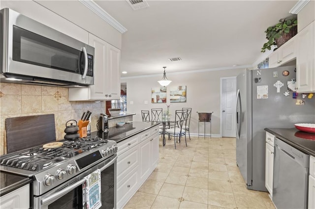 4412 Clearlake Dr, Metairie, LA 70006 - kitchen featuring appliances with stainless steel finishes, ornamental molding, dark countertops, decorative backsplash, and white cabinets