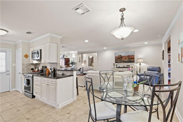 4412 Clearlake Dr, Metairie, LA 70006 - dining space featuring crown molding and recessed lighting