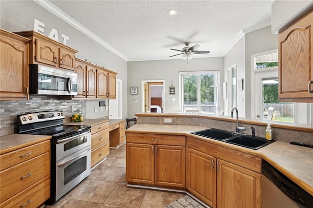 101 Tammy Dr, Slidell, LA 70458 - kitchen featuring appliances with stainless steel finishes, tasteful backsplash, a textured ceiling, a ceiling fan, and light tile patterned floors