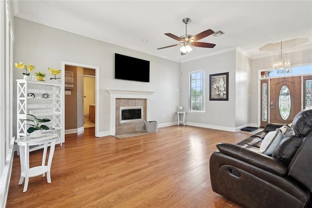101 Tammy Dr, Slidell, LA 70458 - living area with ornamental molding, light wood-type flooring, a fireplace, ceiling fan, and a chandelier