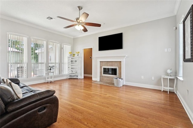 101 Tammy Dr, Slidell, LA 70458 - living room with a ceiling fan, light wood finished floors, ornamental molding, and a fireplace