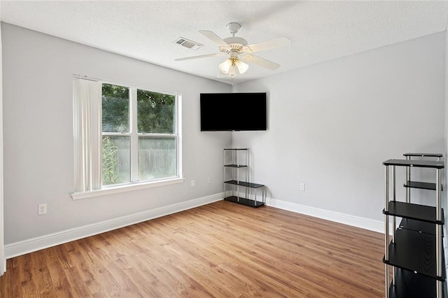 101 Tammy Dr, Slidell, LA 70458 - unfurnished living room featuring wood finished floors, ceiling fan, and a textured ceiling