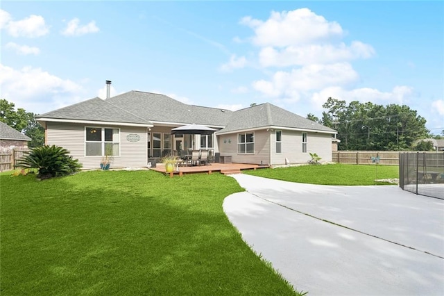 101 Tammy Dr, Slidell, LA 70458 - rear view of house featuring a fenced backyard, a wooden deck, a trampoline, a patio area, and outdoor dining area