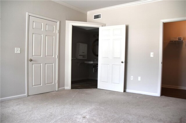 350 Emerald Forrest Blvd Unit 24103, Covington, LA 70433 - unfurnished bedroom with carpet flooring, crown molding, and a spacious closet