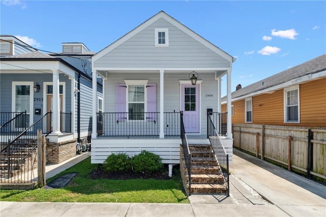2909 Amelia St, New Orleans, LA 70115 - shotgun-style home featuring covered porch