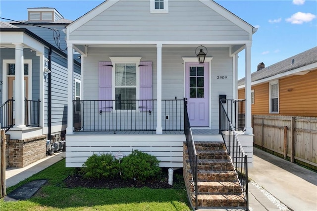 2909 Amelia St, New Orleans, LA 70115 - shotgun-style home featuring a porch