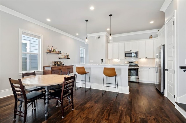 2909 Amelia St, New Orleans, LA 70115 - dining area with ornamental molding, dark wood-style floors, and recessed lighting