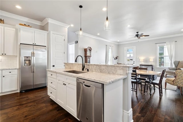 2909 Amelia St, New Orleans, LA 70115 - kitchen featuring appliances with stainless steel finishes, open floor plan, ornamental molding, recessed lighting, and dark wood finished floors