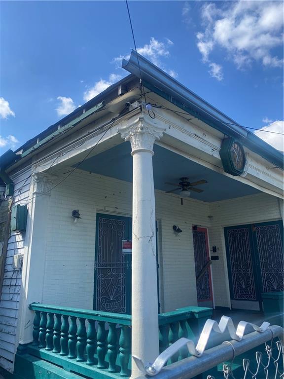 1122 Henriette Delille St, New Orleans, LA 70116 - view of home's exterior featuring a porch, brick siding, and ceiling fan