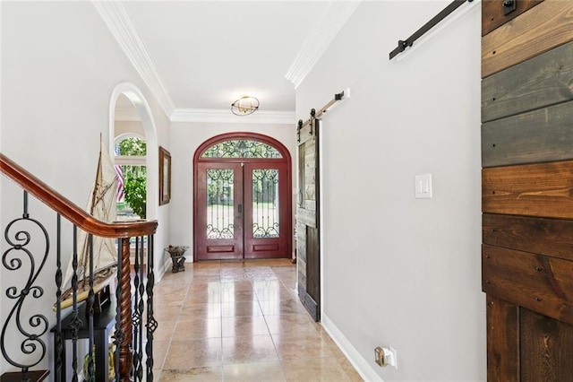 299 Sarah Victoria Dr, Belle Chasse, LA 70037 - foyer featuring a barn door, ornamental molding, french doors, stairs, and light tile patterned floors
