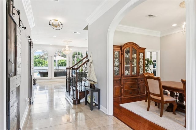 299 Sarah Victoria Dr, Belle Chasse, LA 70037 - entryway featuring a chandelier, arched walkways, ornamental molding, light tile patterned floors, and recessed lighting