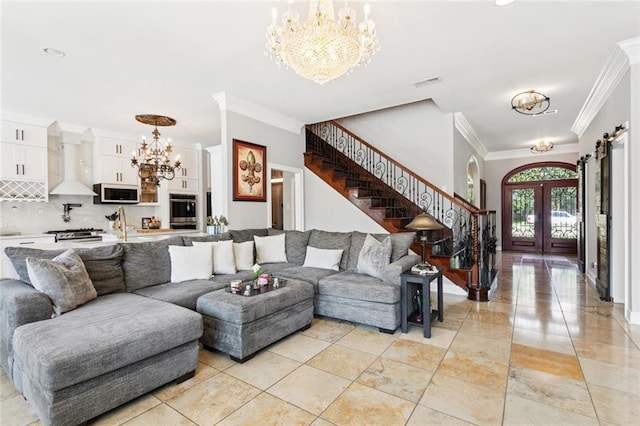 299 Sarah Victoria Dr, Belle Chasse, LA 70037 - living room with a chandelier, french doors, crown molding, and stairs