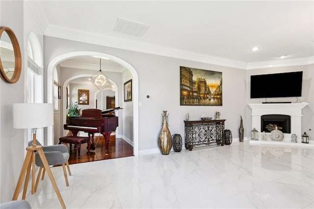 299 Sarah Victoria Dr, Belle Chasse, LA 70037 - living room featuring crown molding, marble finish floors, arched walkways, a fireplace with raised hearth, and recessed lighting