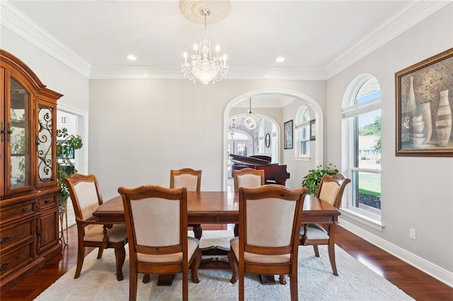 299 Sarah Victoria Dr, Belle Chasse, LA 70037 - dining area featuring a chandelier, wood finished floors, arched walkways, crown molding, and recessed lighting