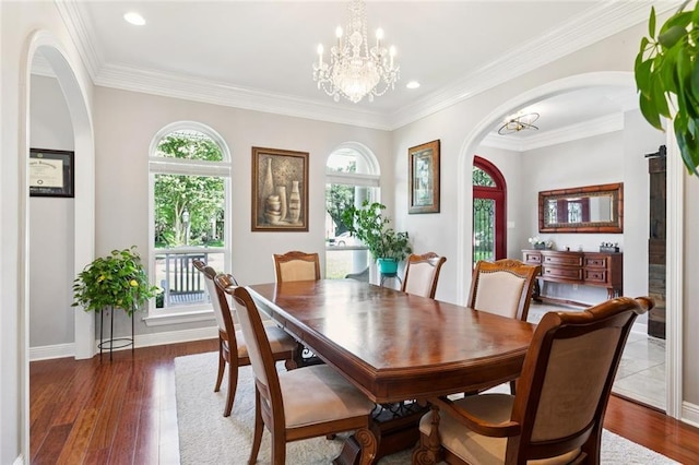 299 Sarah Victoria Dr, Belle Chasse, LA 70037 - dining room featuring arched walkways, healthy amount of natural light, a chandelier, wood finished floors, and recessed lighting