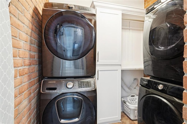 299 Sarah Victoria Dr, Belle Chasse, LA 70037 - laundry room with stacked washer / dryer and cabinet space