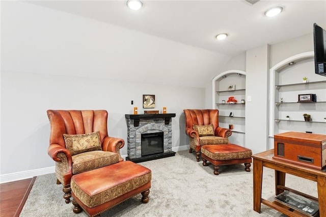299 Sarah Victoria Dr, Belle Chasse, LA 70037 - sitting room featuring built in shelves, a stone fireplace, and vaulted ceiling