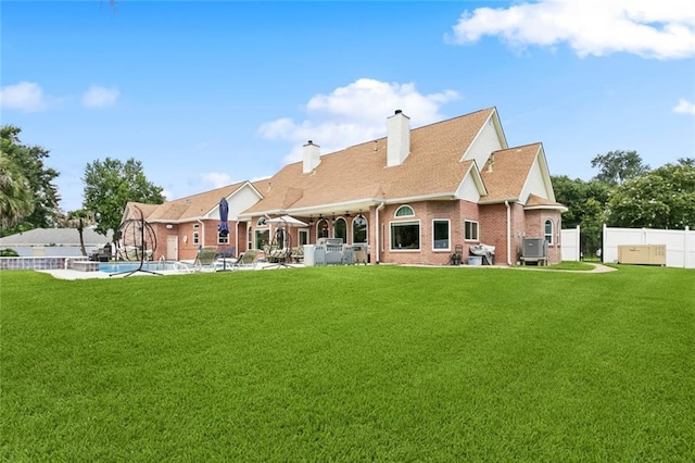 299 Sarah Victoria Dr, Belle Chasse, LA 70037 - back of property featuring brick siding, a chimney, and a patio