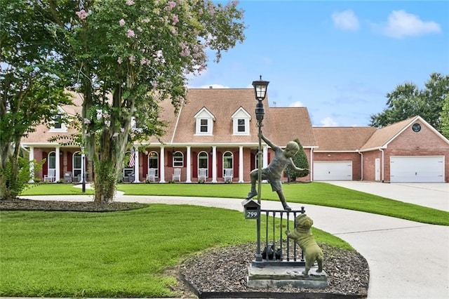 299 Sarah Victoria Dr, Belle Chasse, LA 70037 - cape cod home with curved driveway, a front yard, a chimney, an attached garage, and brick siding