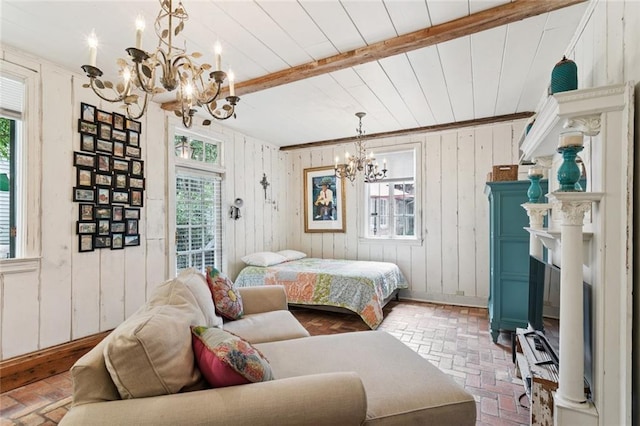 718 Ursulines Ave Unit D, New Orleans, LA 70116 - bedroom with a chandelier, brick floors, wooden walls, and a wooden ceiling with exposed beams