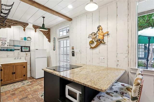 718 Ursulines Ave Unit D, New Orleans, LA 70116 - kitchen featuring white appliances, brick patterned flooring, brown cabinetry, beamed ceiling, and wooden walls