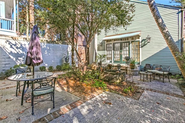 718 Ursulines Ave Unit D, New Orleans, LA 70116 - view of patio featuring outdoor dining space and french doors