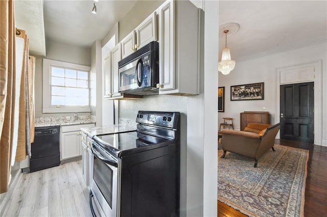 2512 Magazine St Unit D, New Orleans, LA 70130 - kitchen with stainless steel electric range, dishwasher, light wood-type flooring, and white cabinets
