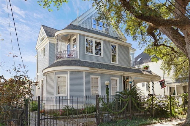 2512 Magazine St Unit D, New Orleans, LA 70130 - victorian home with roof with shingles and a fenced front yard