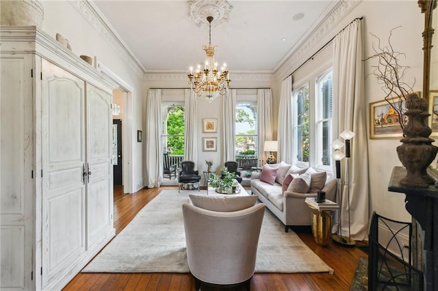 639 Esplanade Ave, New Orleans, LA 70116 - living area featuring wood-type flooring, a chandelier, and crown molding