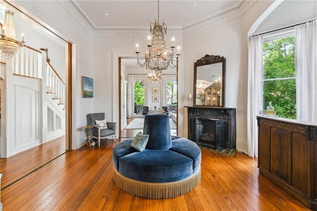 639 Esplanade Ave, New Orleans, LA 70116 - living area with hardwood / wood-style flooring, a fireplace, healthy amount of natural light, stairway, and crown molding