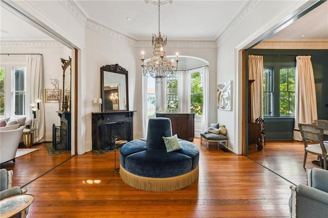 639 Esplanade Ave, New Orleans, LA 70116 - living area featuring hardwood / wood-style flooring, a chandelier, healthy amount of natural light, and a fireplace with flush hearth