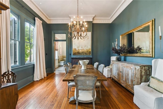 639 Esplanade Ave, New Orleans, LA 70116 - dining area with a chandelier, hardwood / wood-style floors, and crown molding