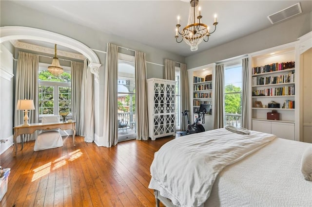639 Esplanade Ave, New Orleans, LA 70116 - bedroom with hardwood / wood-style flooring, access to outside, and a chandelier