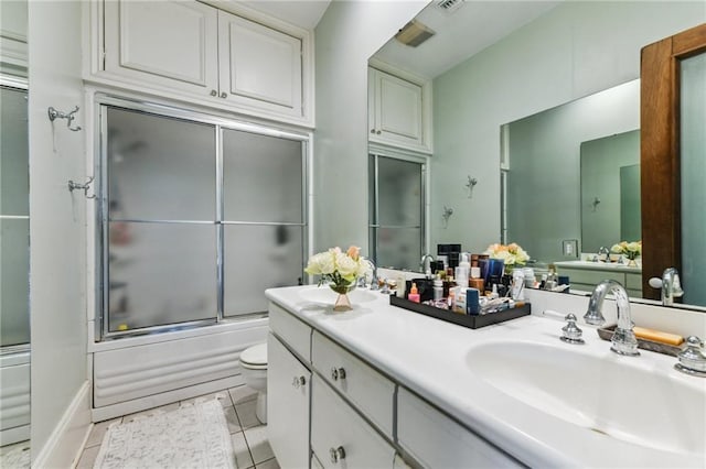 639 Esplanade Ave, New Orleans, LA 70116 - bathroom featuring enclosed tub / shower combo, double vanity, and tile patterned flooring