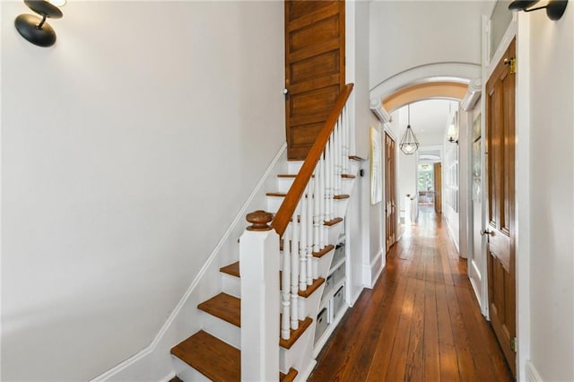 639 Esplanade Ave, New Orleans, LA 70116 - stairs featuring arched walkways and hardwood / wood-style floors