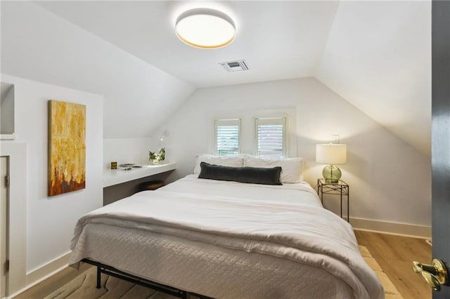 639 Esplanade Ave, New Orleans, LA 70116 - bedroom featuring wood finished floors and vaulted ceiling