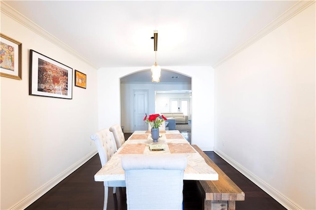 6640 Louisville St, New Orleans, LA 70124 - dining space with arched walkways, dark wood-style flooring, and ornamental molding
