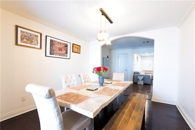 6640 Louisville St, New Orleans, LA 70124 - dining space featuring arched walkways, dark wood-style flooring, and crown molding