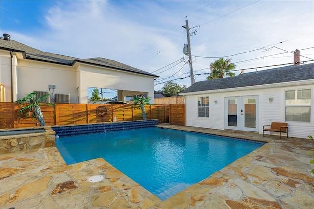 6640 Louisville St, New Orleans, LA 70124 - view of swimming pool featuring french doors, a fenced backyard, a patio, and a pool with connected hot tub