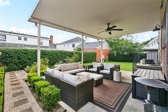 4519 Bancroft Dr, New Orleans, LA 70122 - fenced backyard featuring an outdoor hangout area, ceiling fan, and a patio