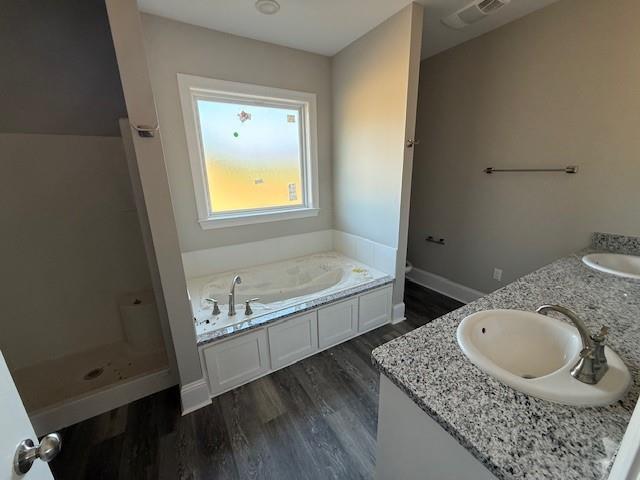 53357 Phillips Path, Loranger, LA 70446 - bathroom with wood finished floors, a bath, double vanity, and a shower