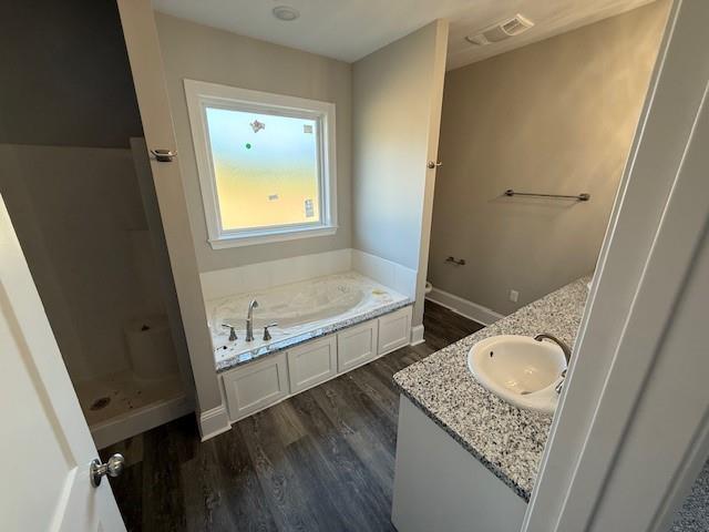 53357 Phillips Path, Loranger, LA 70446 - full bath with wood finished floors, double vanity, and a bath